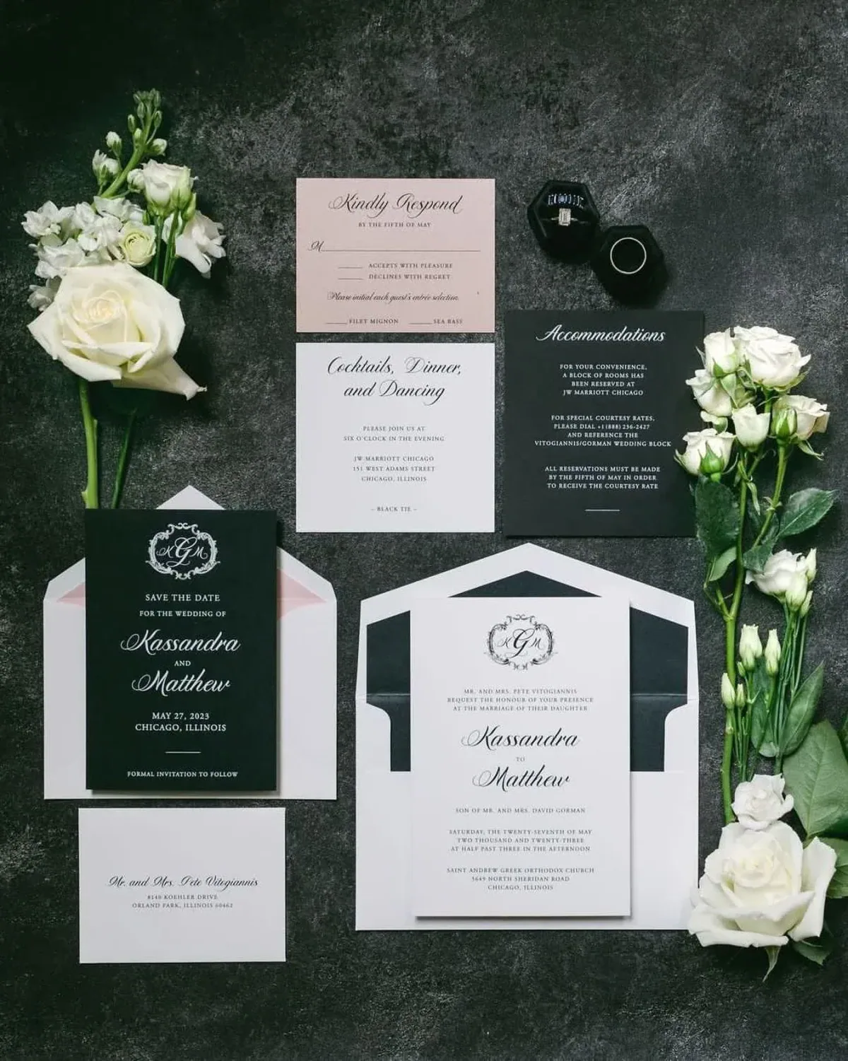 Black and white wedding suite with monogram, styled on dark stone