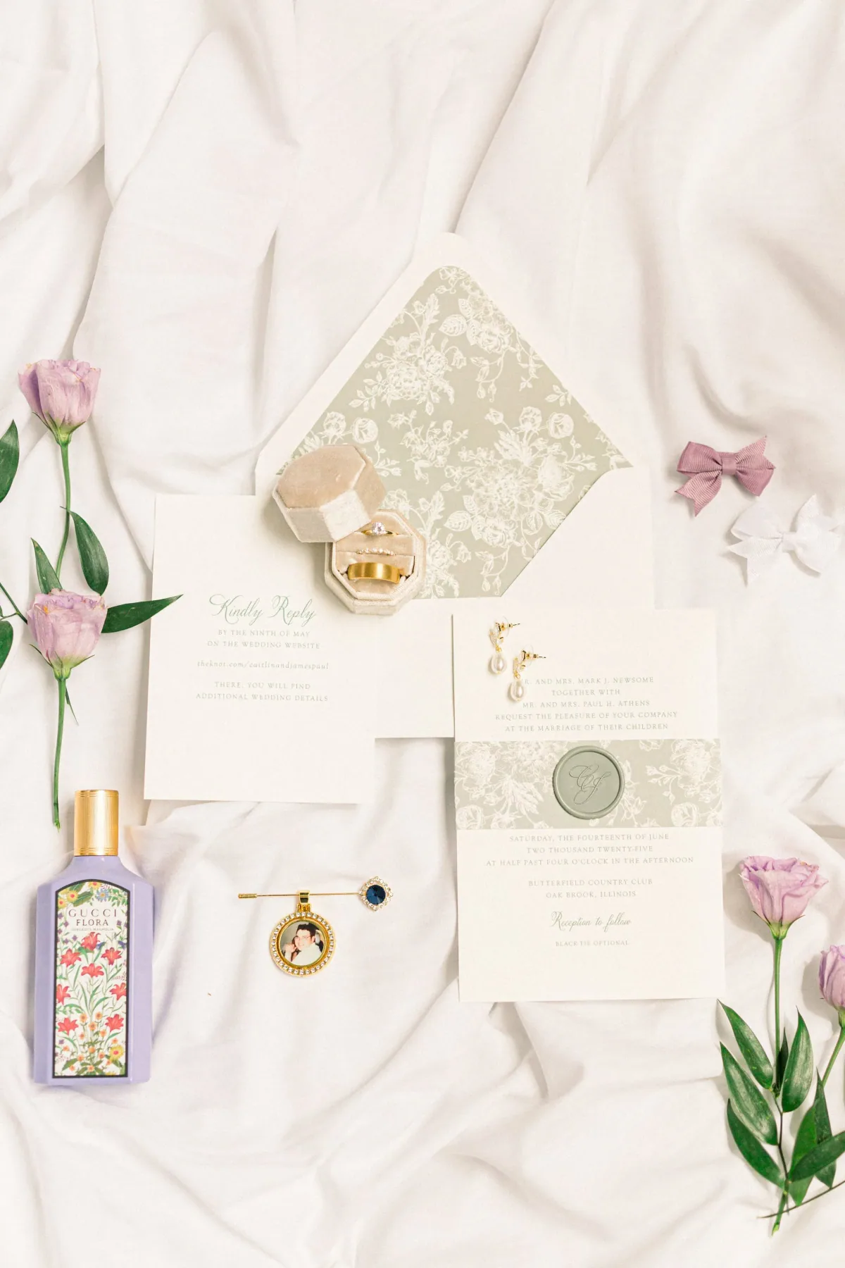Ivory wedding suite with a sage floral envelope liner and wax seal