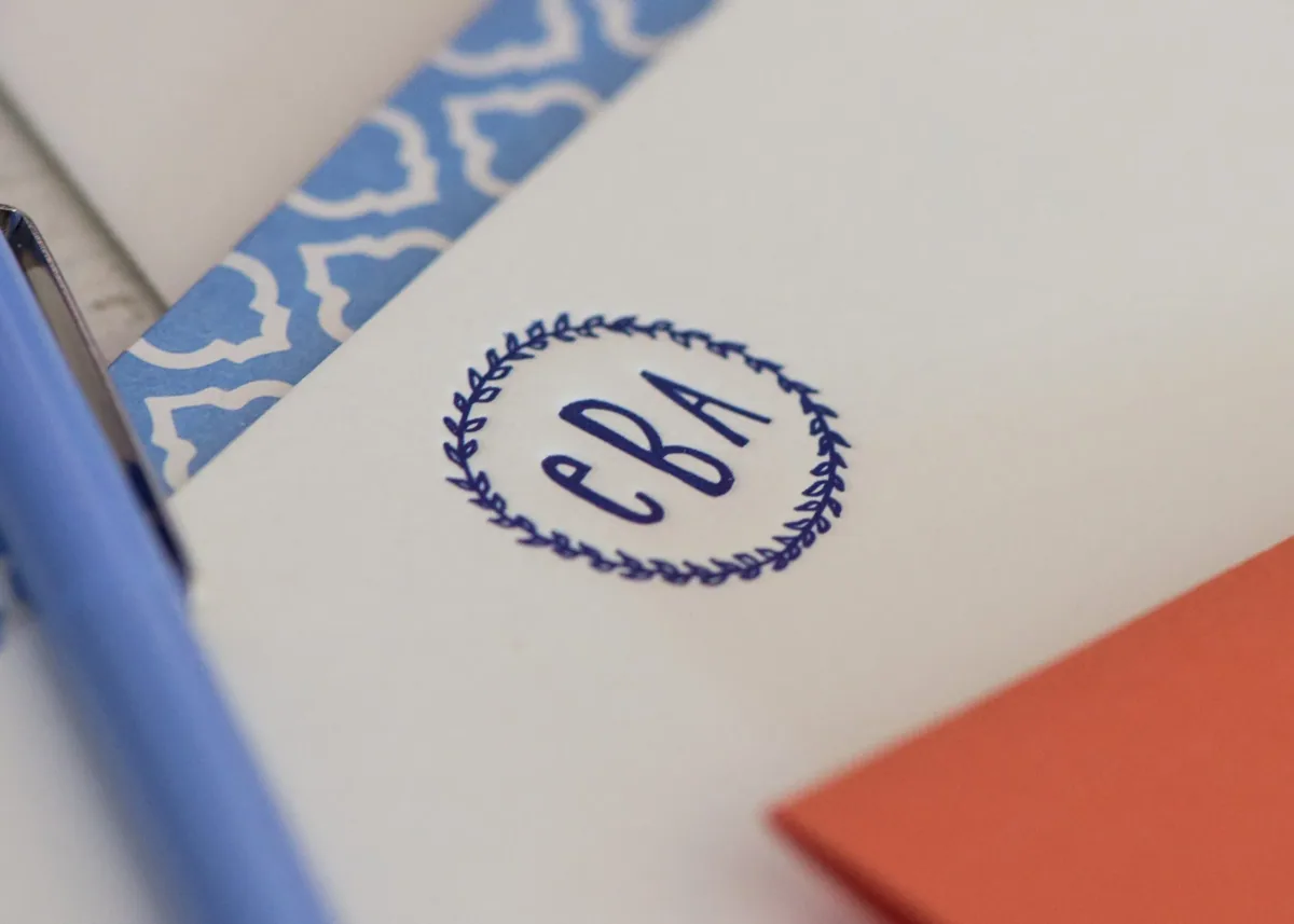 Personal note card with a navy wreath monogram and patterned blue envelope liner