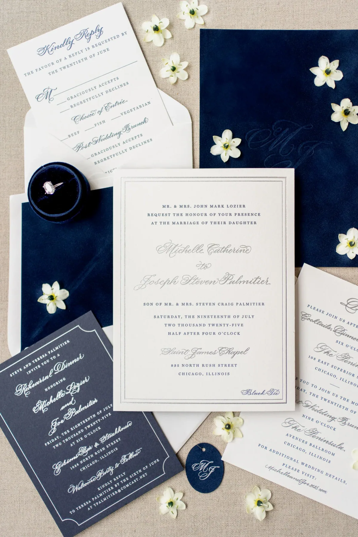 Bordered invitation with navy envelope and small white blossoms