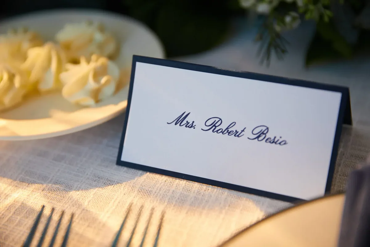 Navy bordered place card at a table setting