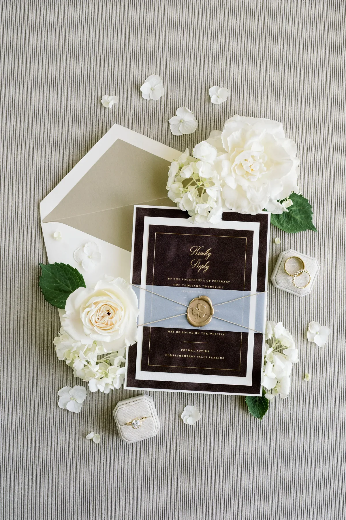 Dark invitation suite with a translucent wrap, cord and gold wax seal
